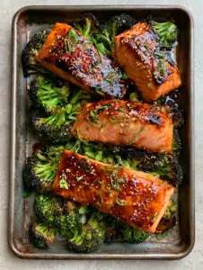 Close-up of bubbling dark amber glaze on Atlantic salmon fillets. (Maple Glazed Baked Salmon)